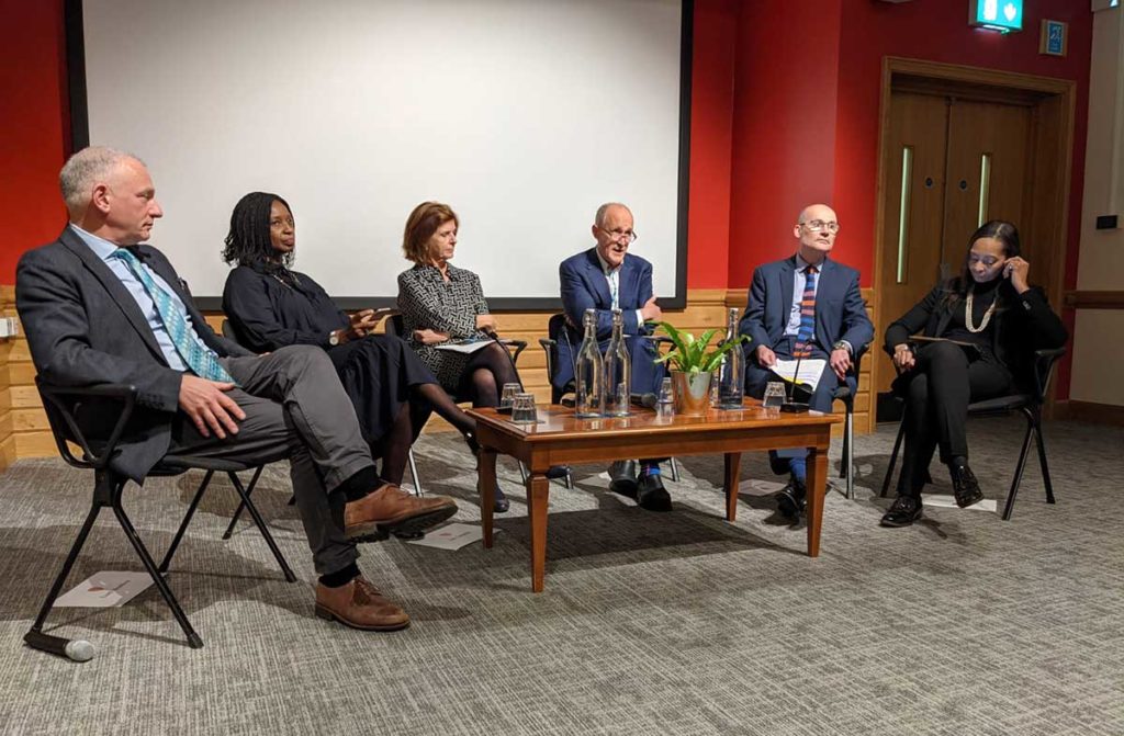 Image showing three men and three women sitting in front of a low coffee table in a lecture theatre