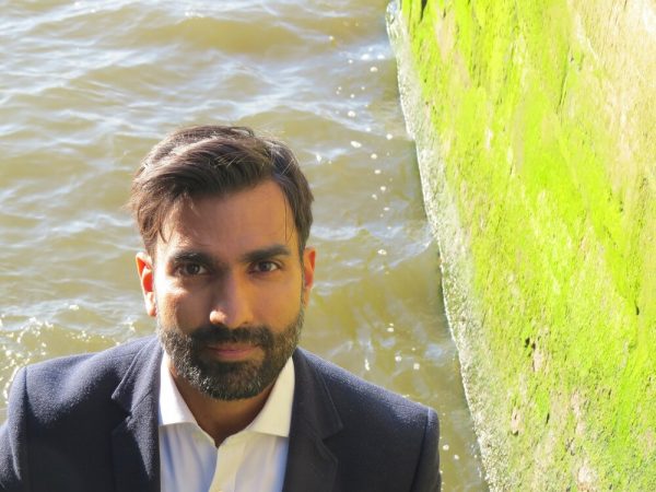 Dr Samir Puri in front of water