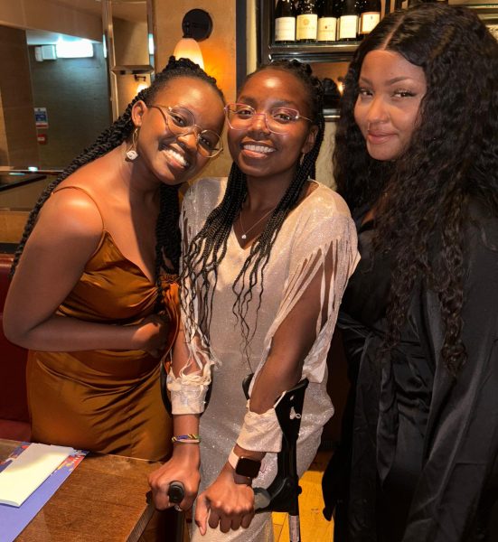 Three women standing together and looking at the camera