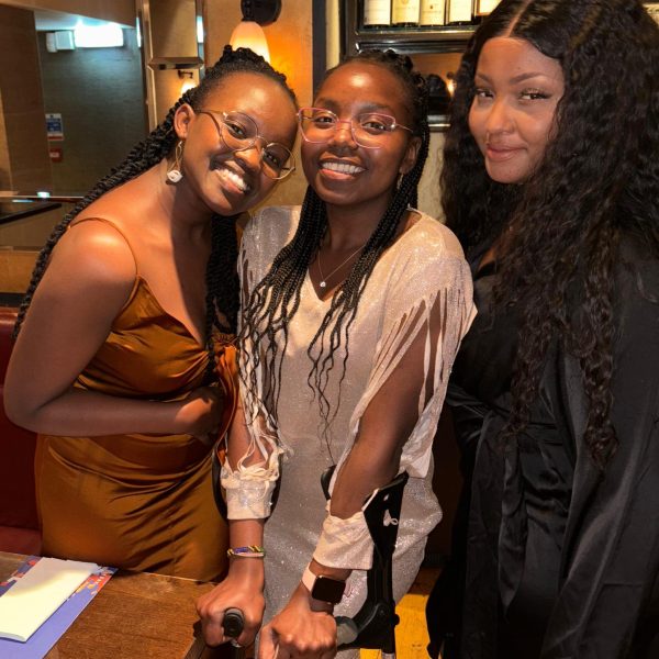 Three women standing together and looking at the camera