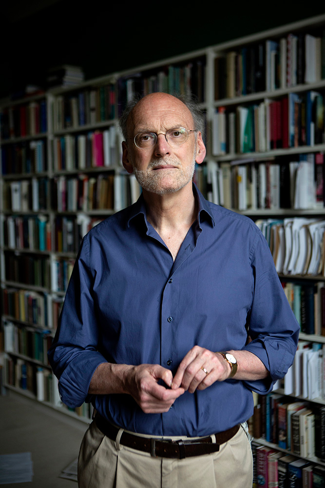 Man stood in front of bookshelves