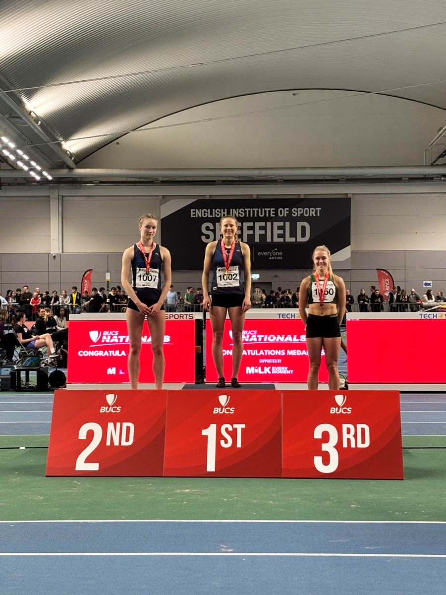 Three female athletes standing on a podium at the British Universities and Colleges Sport indoor championships