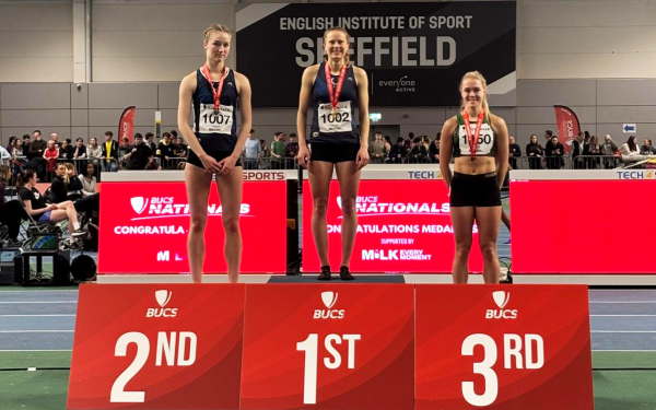 Three female athletes standing on a podium at the British Universities and Colleges Sport indoor championships