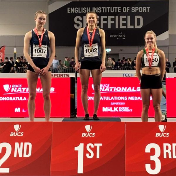 Three female athletes standing on a podium at the British Universities and Colleges Sport indoor championships