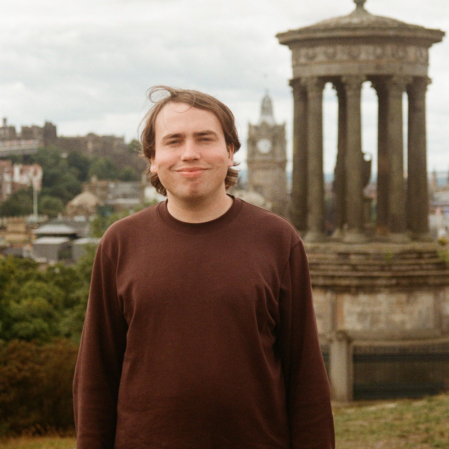 A man wearing a brown jumper.